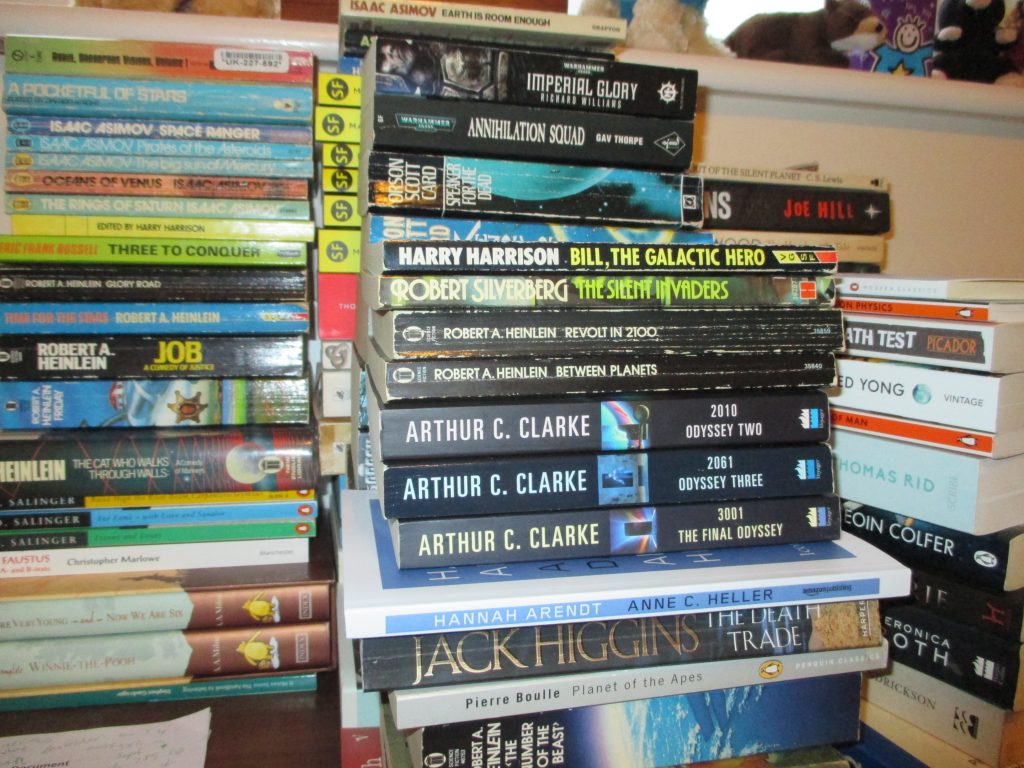 Six piles of books ready to read.